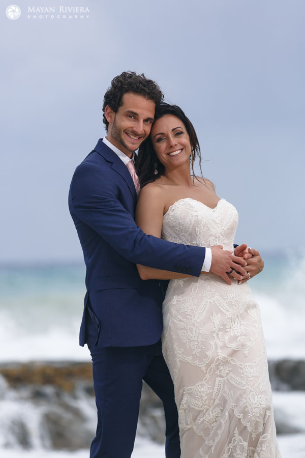 GroomHoldsBrideStandingOnRock