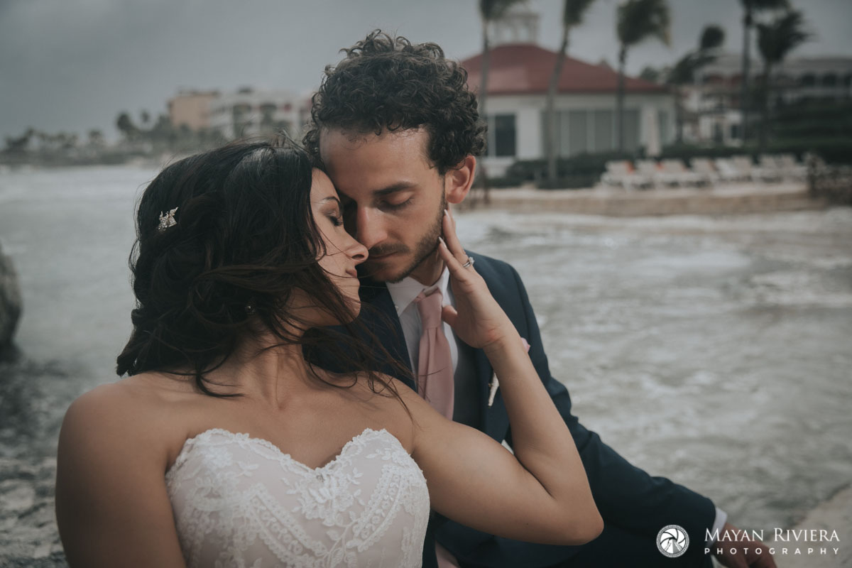 BrideHoldsGroomsFace