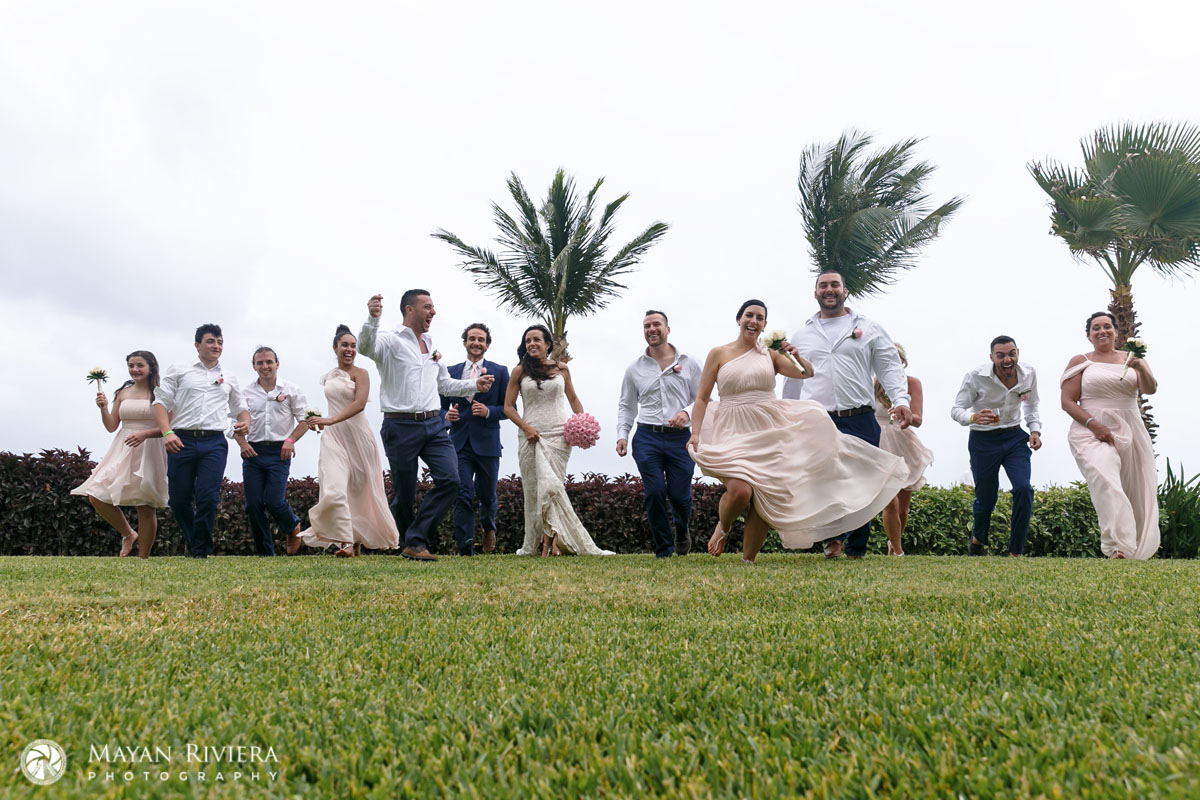 WeddingPartyRunsAcrossLawn