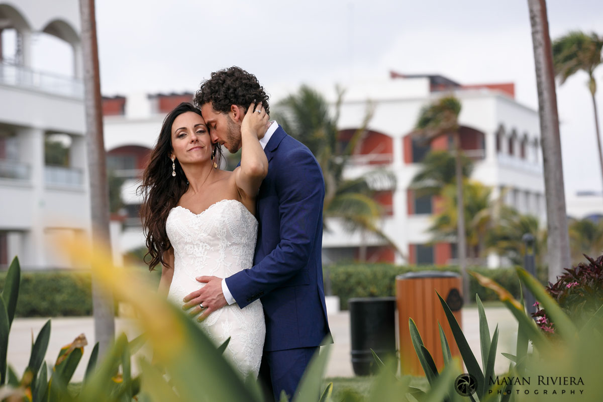NewlywedsHoldEachOtherOnGardenPath