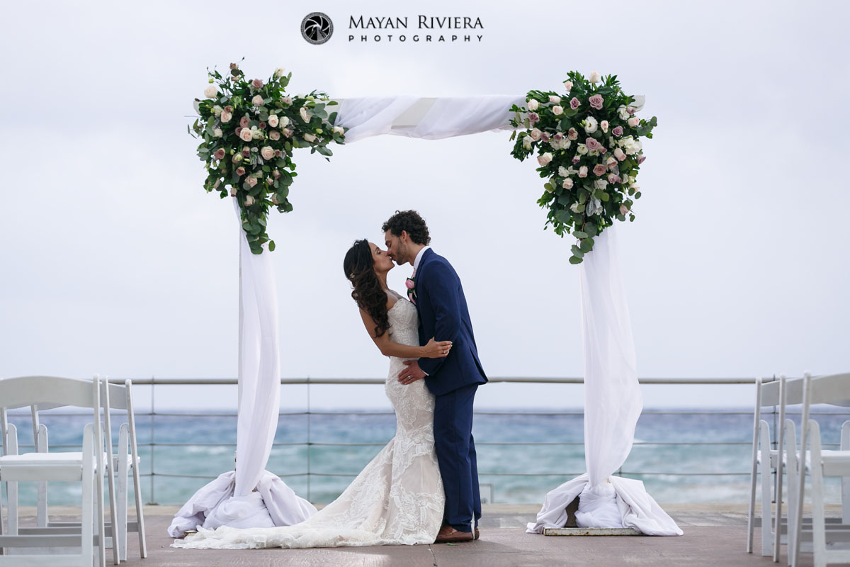 Newlyweds Kiss Under the Ceremony Arch