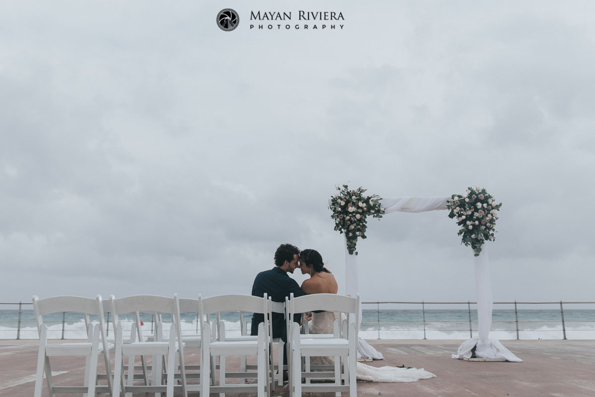 NewlywedsSitOnCeremonyChairs