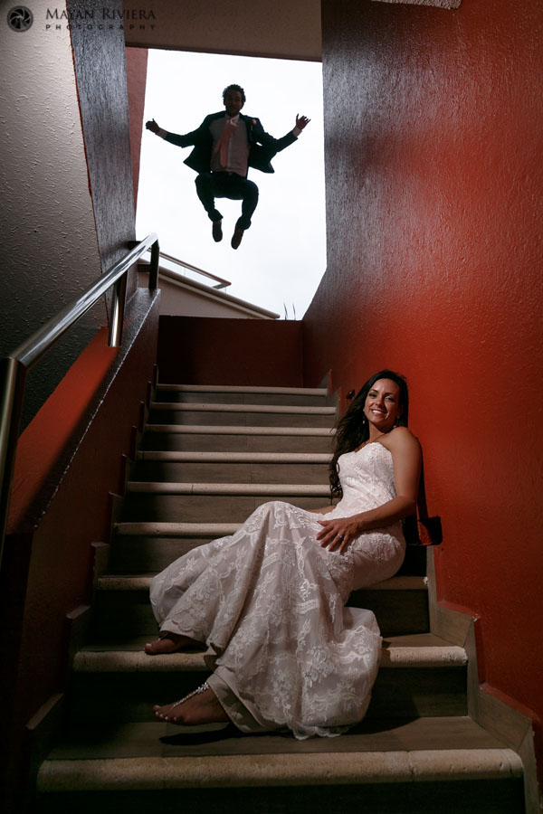 GroomJumpsInStaircaseBehindBride
