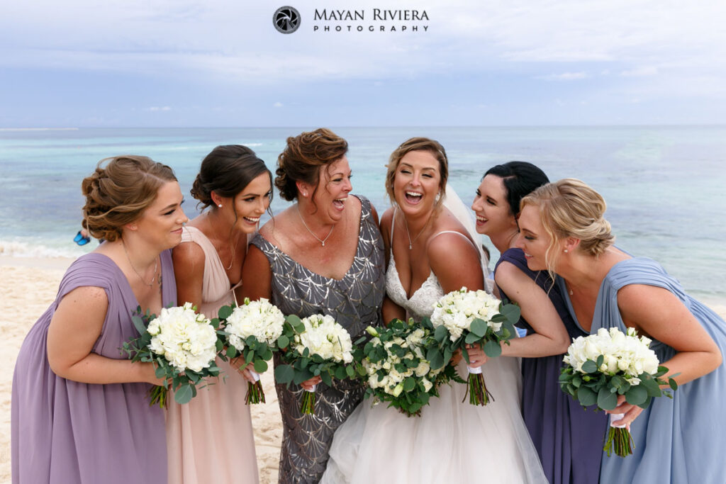 BridesmaidsHugBrideOnBeach