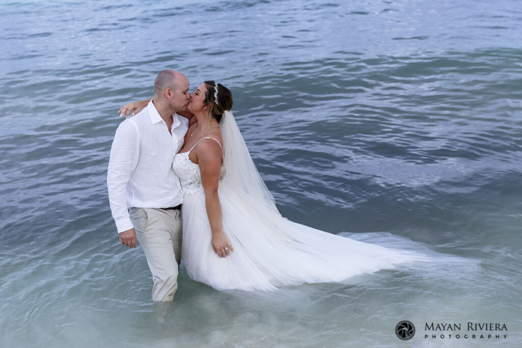 NewlywedsKissStandingInOcean
