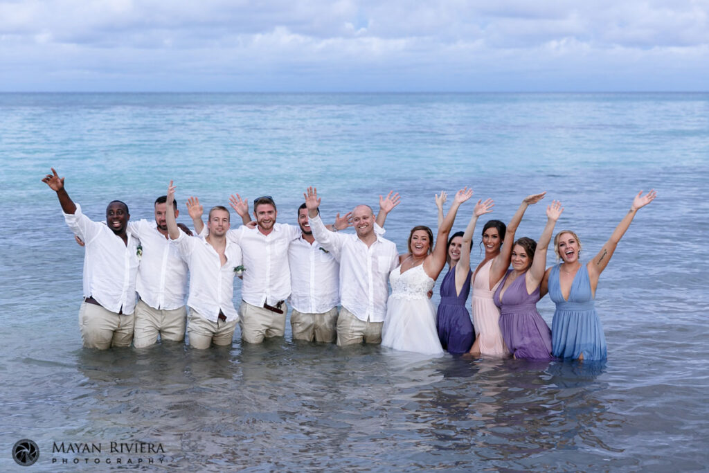 WeddingPartyRaisesArmsStandingInOcean