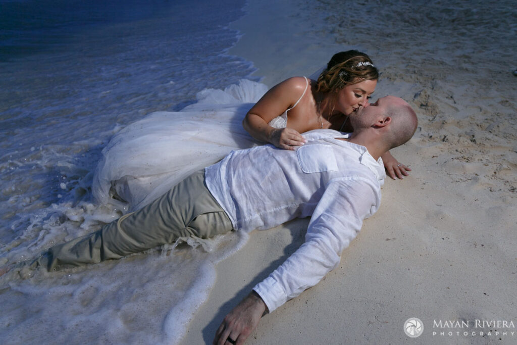 NewlywedsKissRecliningOnBeach