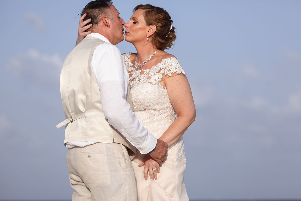 NewlywedsKissOnBeach