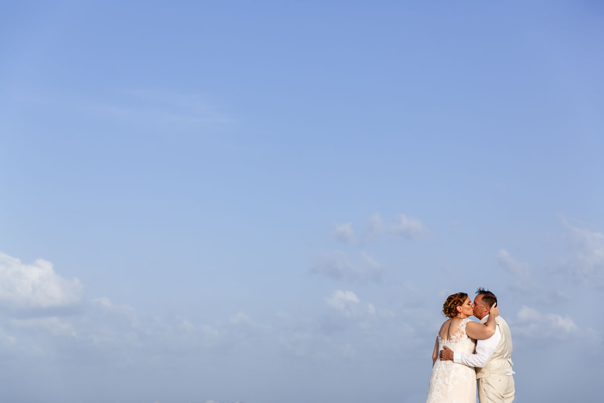 NewlywedsKissOnBeach