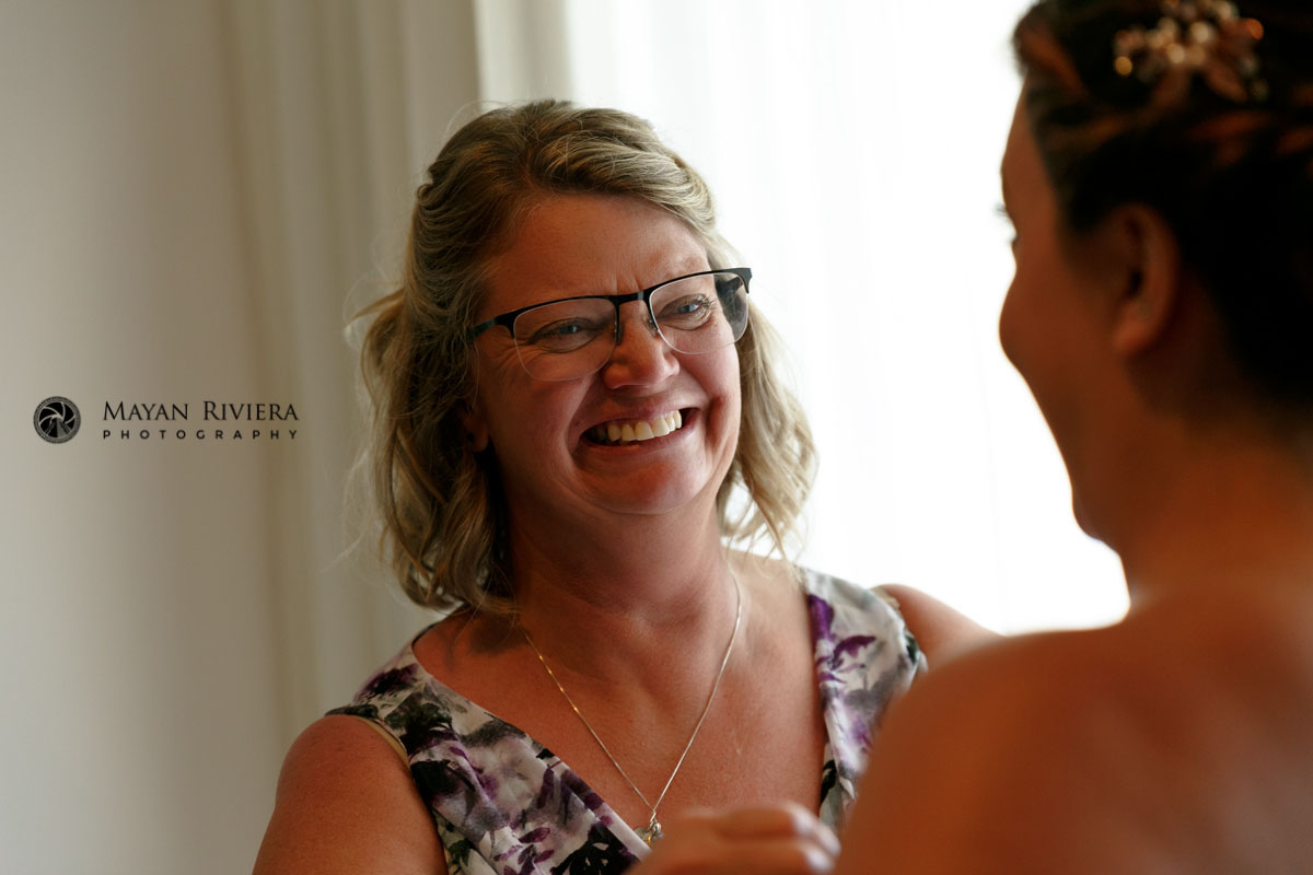 BeamingMomHelpsBrideDaughterDressing