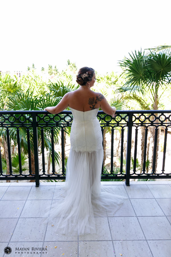 MomBrideLooksOutOverBalcony