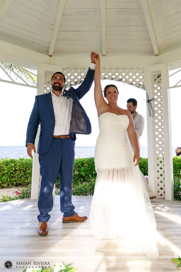 NewlywedsRaiseArmsInCheer