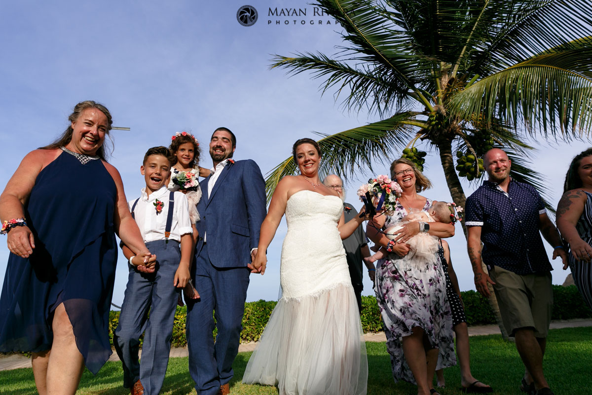 CheeringFriendsAndFamilyWalkWithNewlyweds