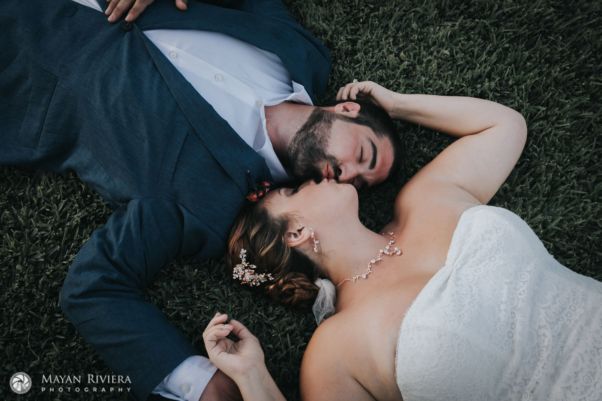 NewlywedsKissLyingOnGrass