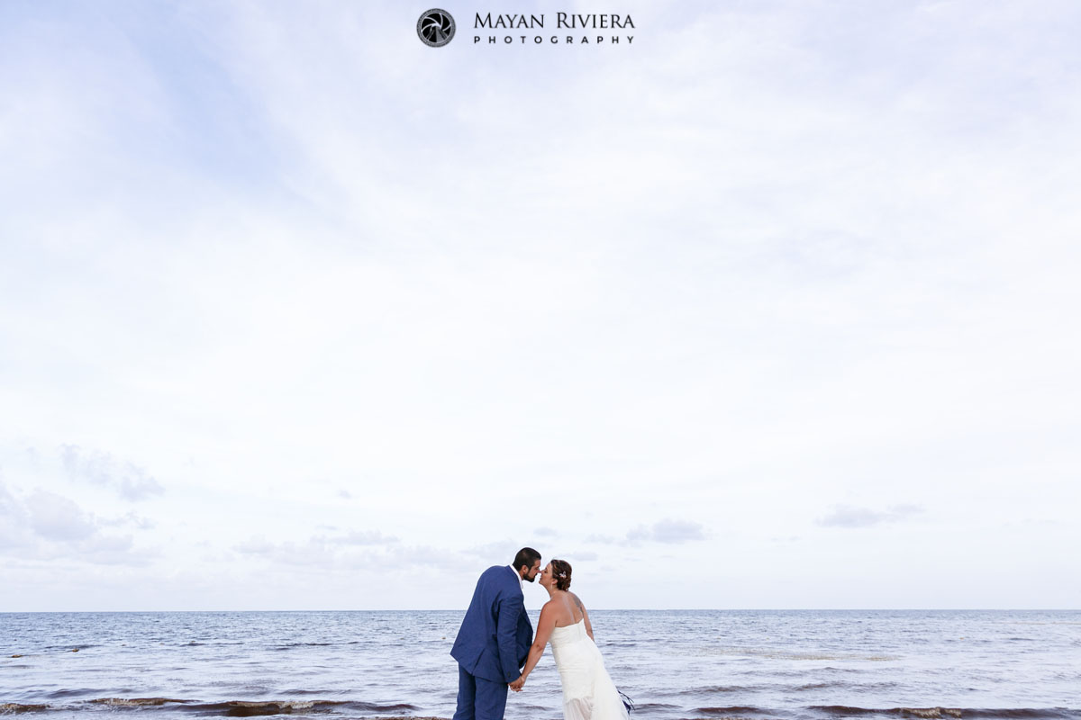 SmilingNewlywedsLeanInOnBeach