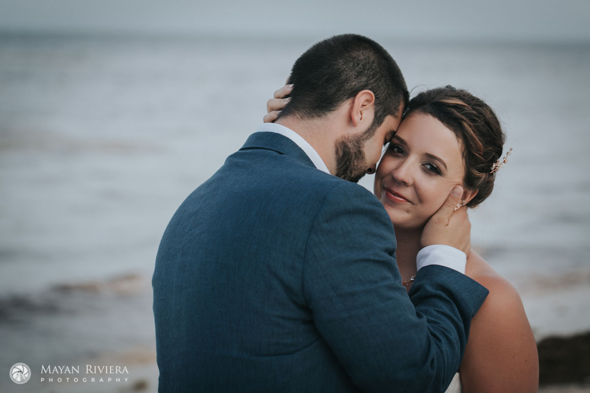 GroomLeansIntoBrideOnBeach