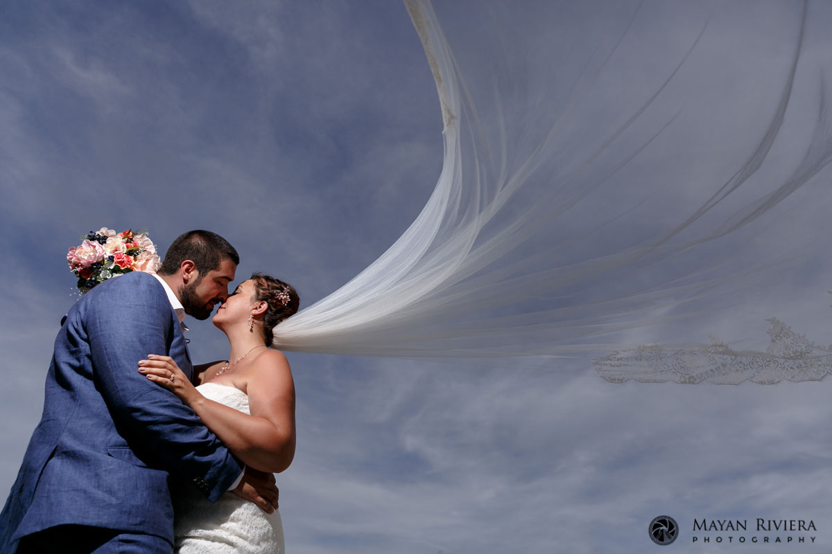 BreezeLiftsBridesVeilDuringNewlywedKiss