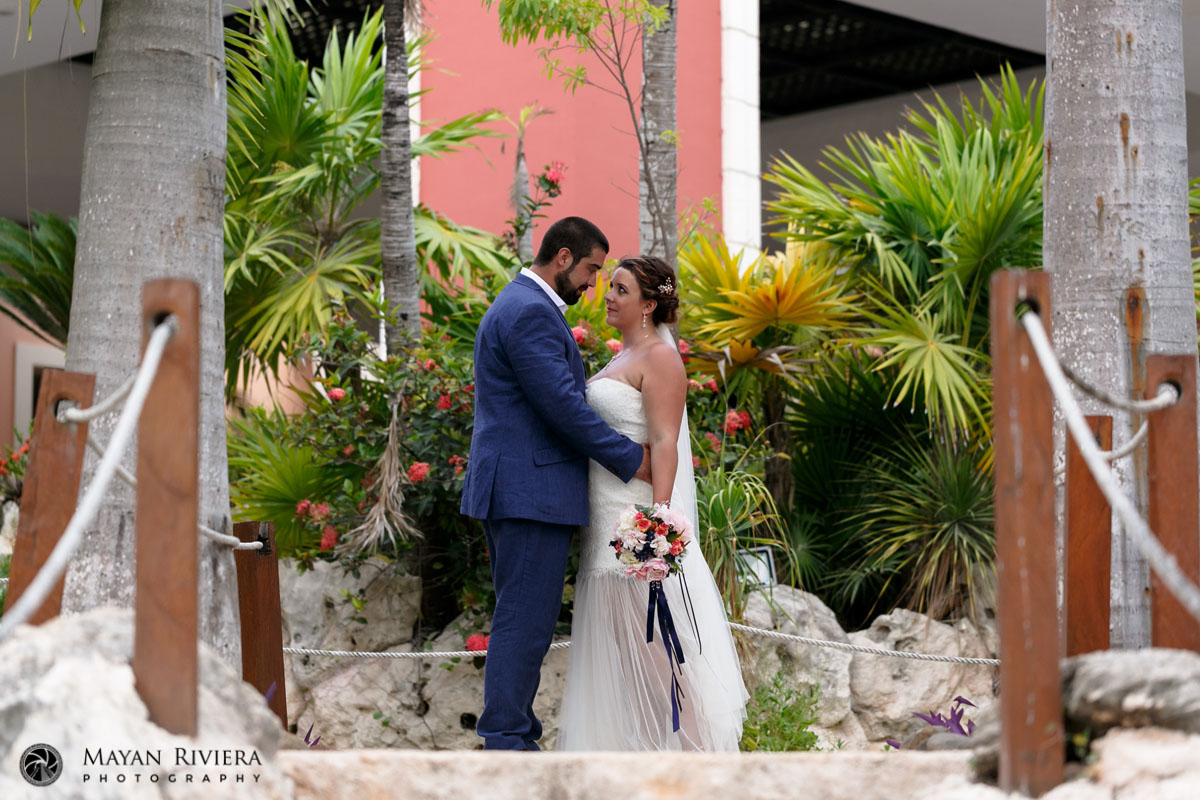 NewlywedsPoseByStoneWall