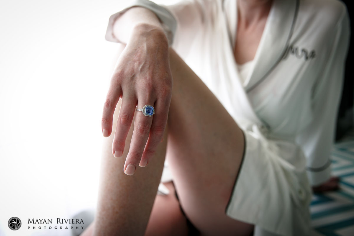 BrideDrapesHandOnKneeShowingRing
