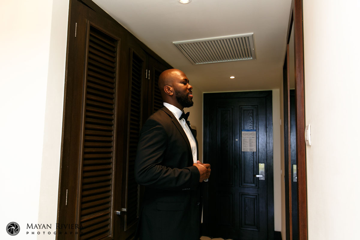 DressedGroomLookingInMirror