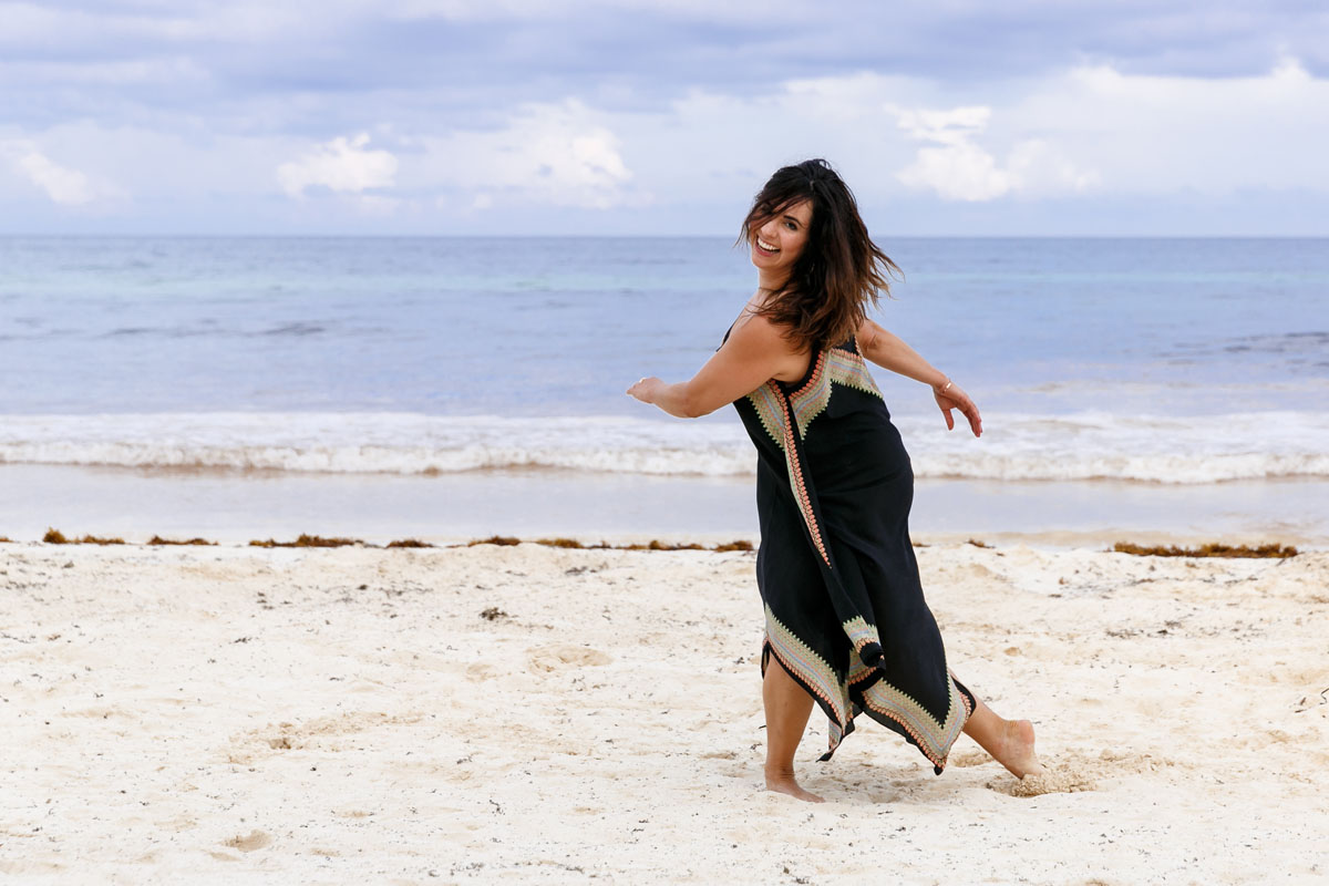 LaughingGirlTwirlsOnBeach
