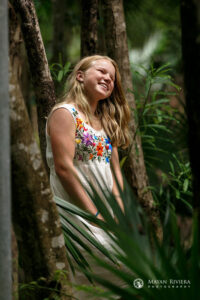 SmilingSaraLeansOnJungleTree