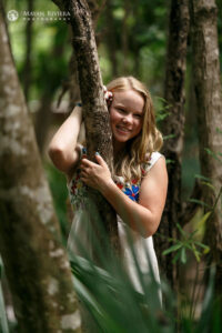 SmilingSaraLeansOnJungleTree