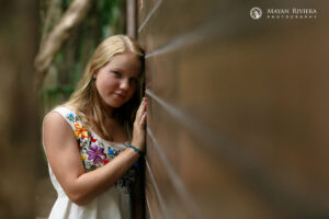 SmilingSaraLeansOnWall