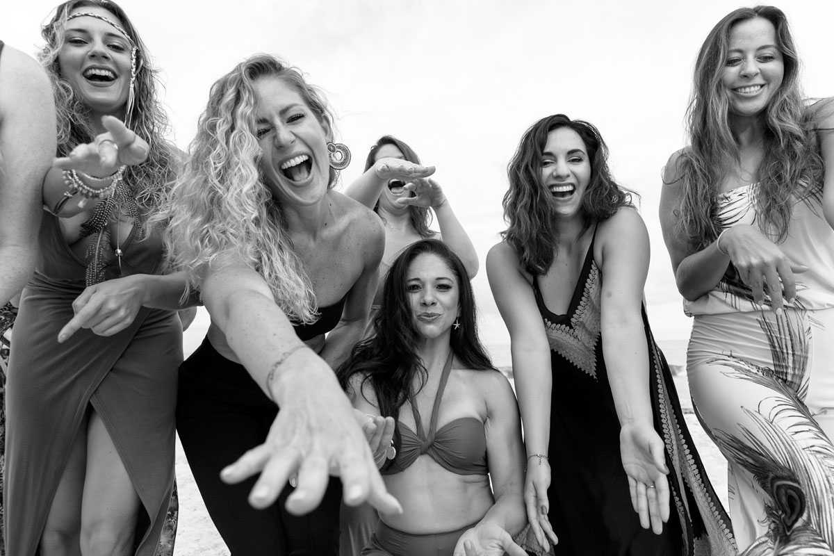 GirlsExtendTheirHandsOnBeachCloseUp