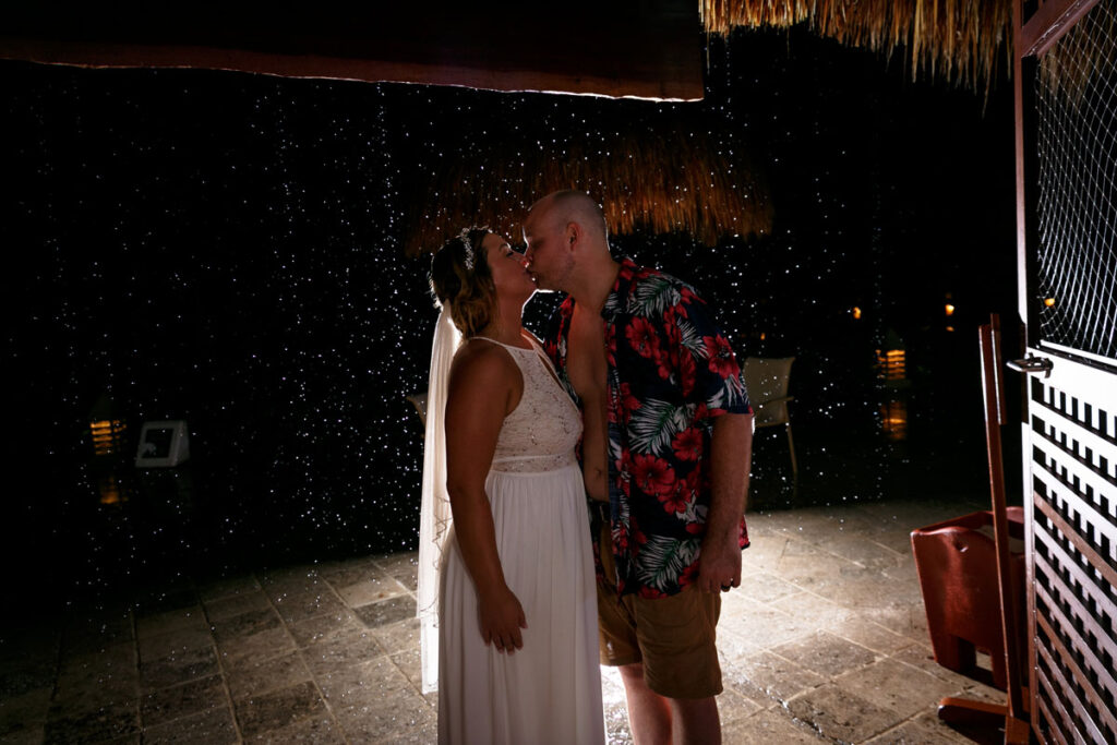 NewlywedsKissInRomanticRainshower