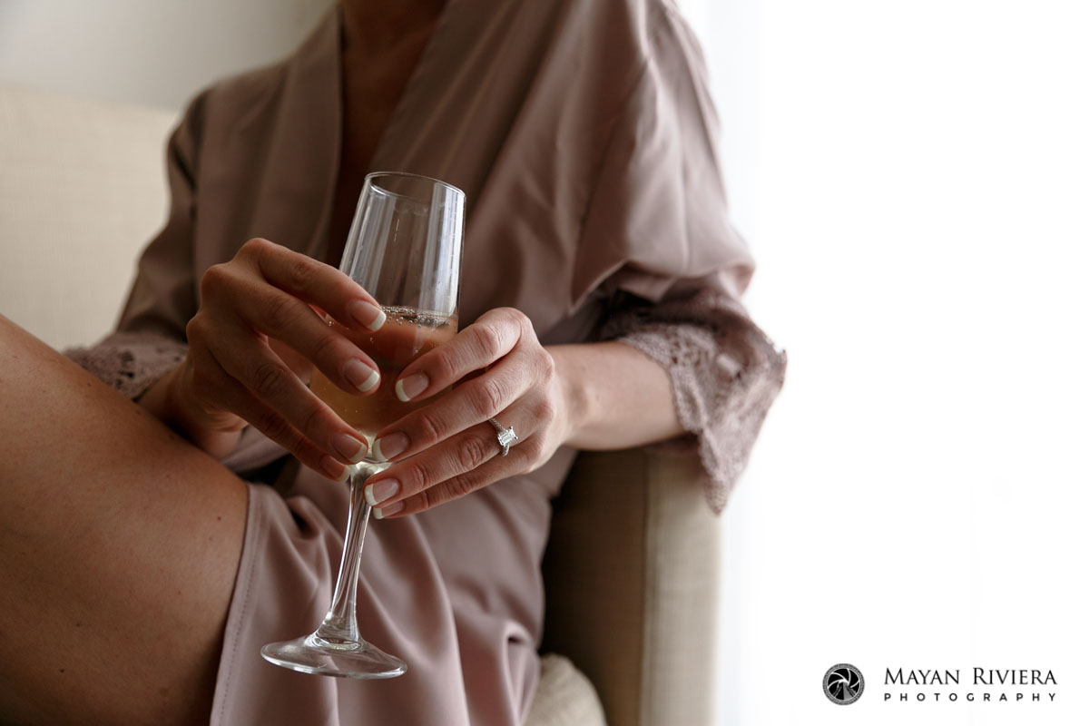 BrideHoldsChampagneShowingRing