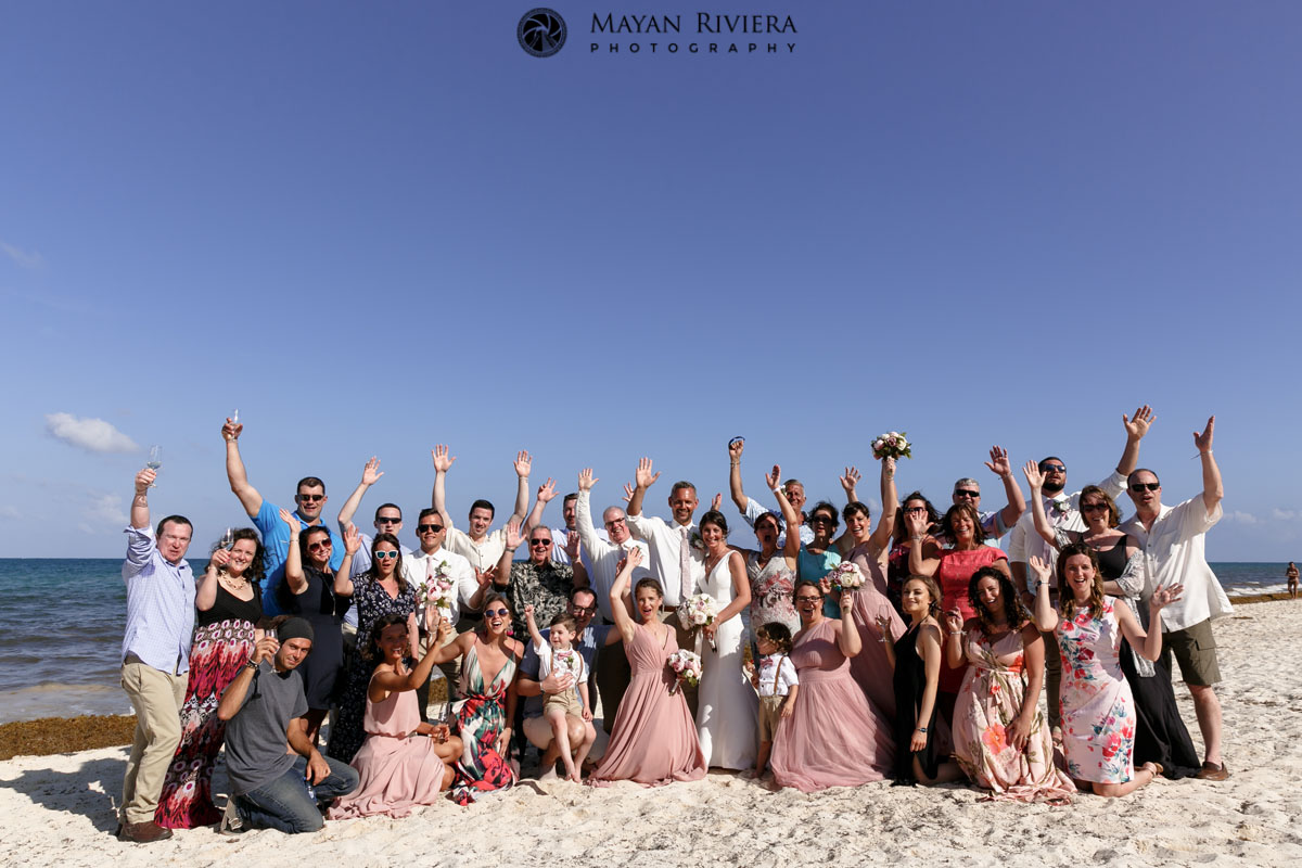 WeddingGuestsCheerOnBeachWithNewlyweds