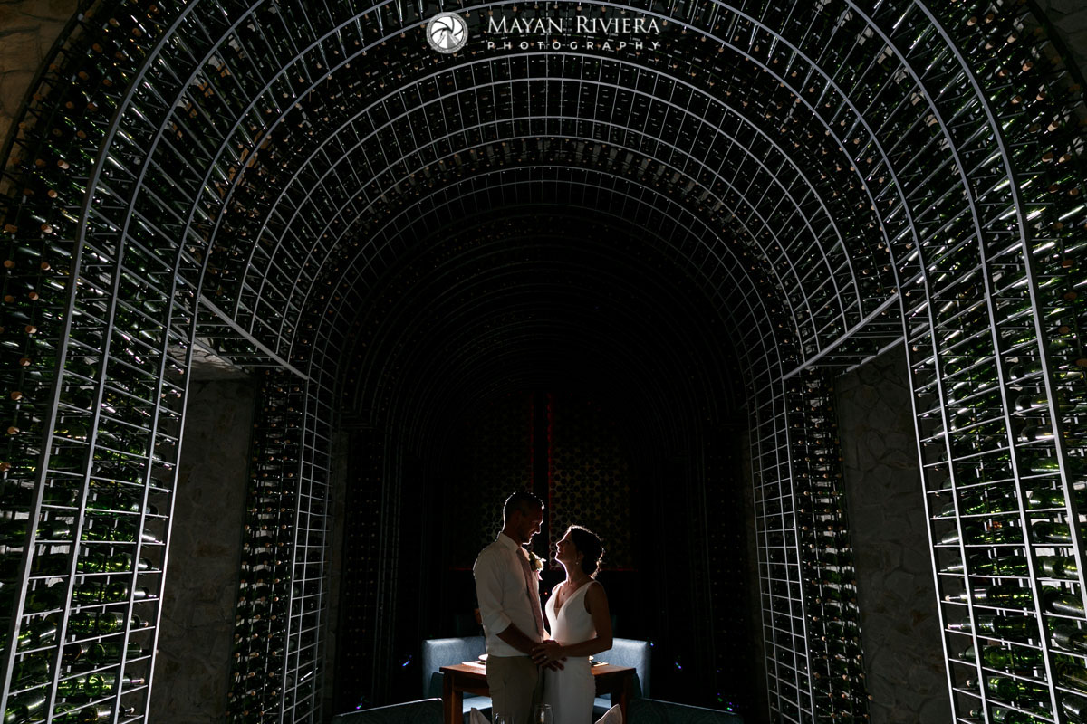 NewlywedsPoseInWineRackTunnel