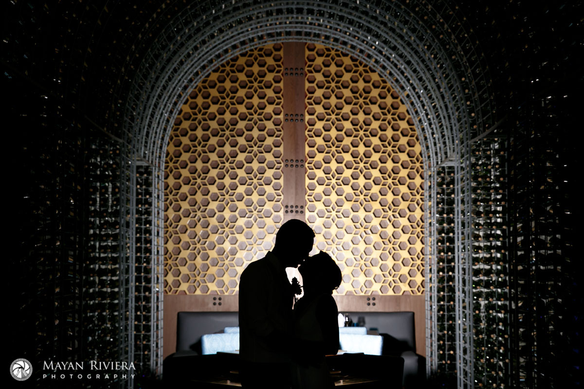 NewlywedsPoseInWineRackTunnel