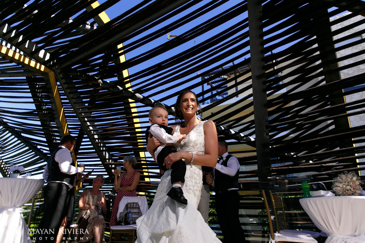 NewlywedMomPosesUnderCeremonyCanopyWithSon