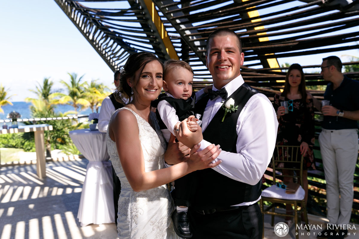 NewlywedsPoseUnderCeremonyCanopyWithSon