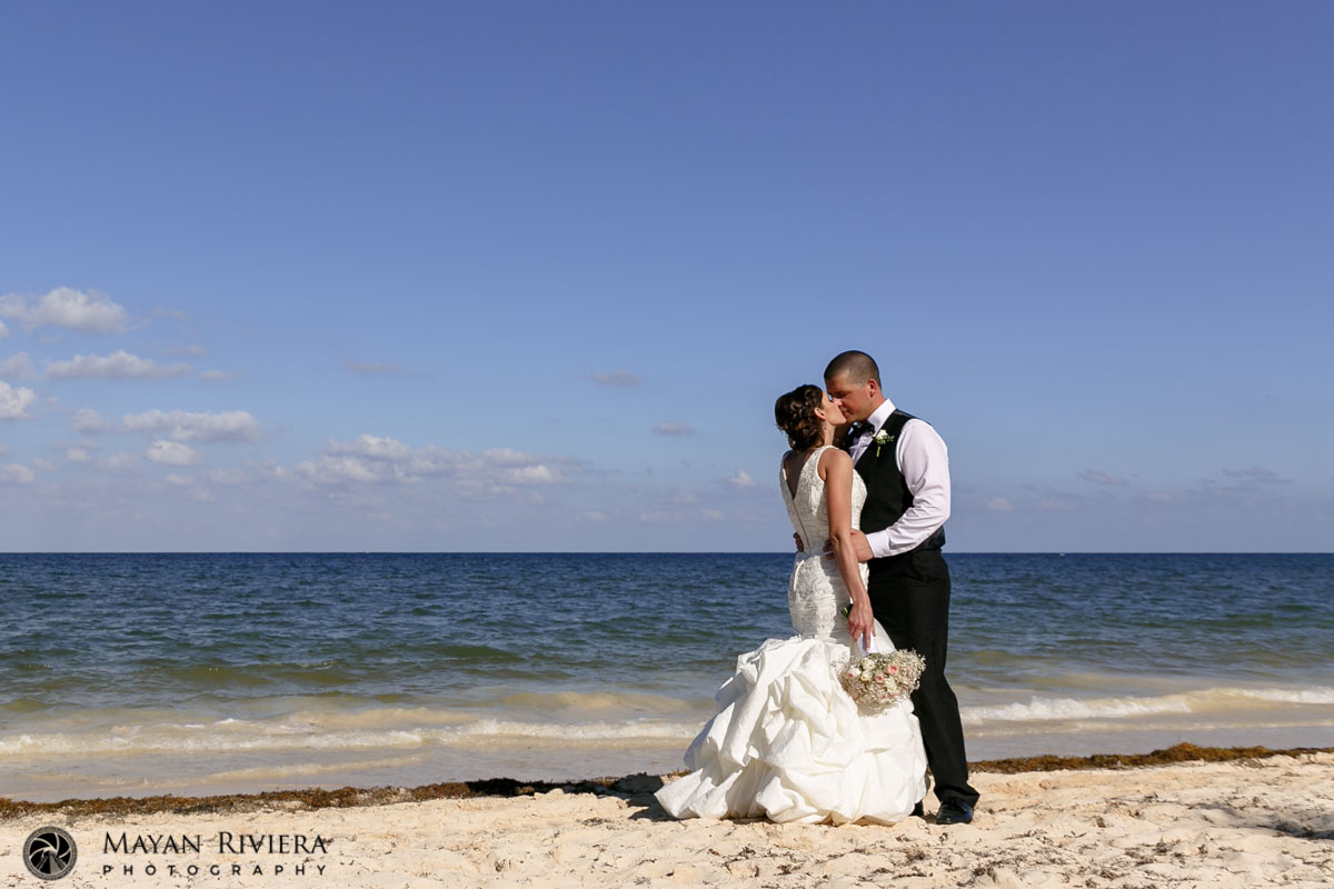 NewlywedsKissOnBeach
