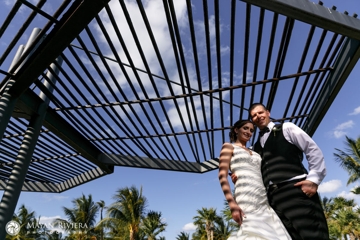 NewlywedsPoseUnderCeremonyCanopy