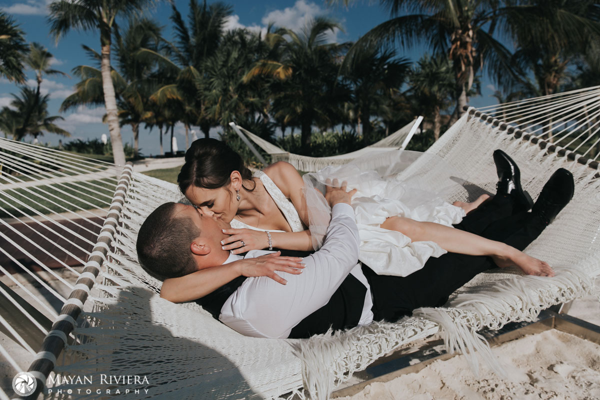 NewlywedsKissOnBeachHammock