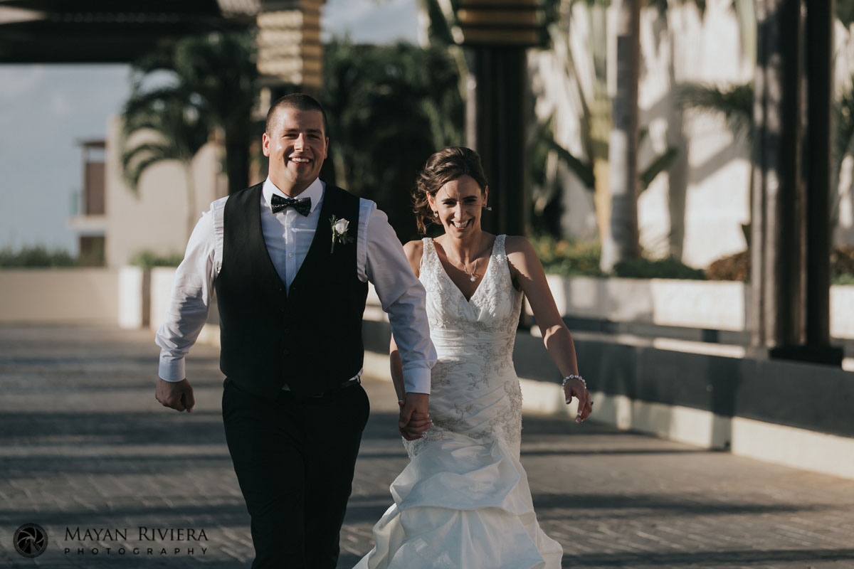 LaughingNewlywedsStrollHandInHand