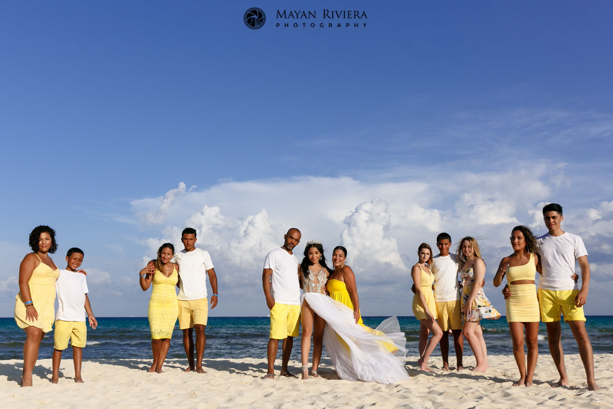 MelaniePosesWithFamilyOnBeach