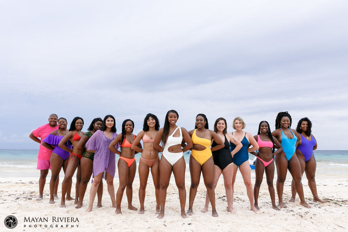 PosingEntourageBacksUpBrideOnBeach