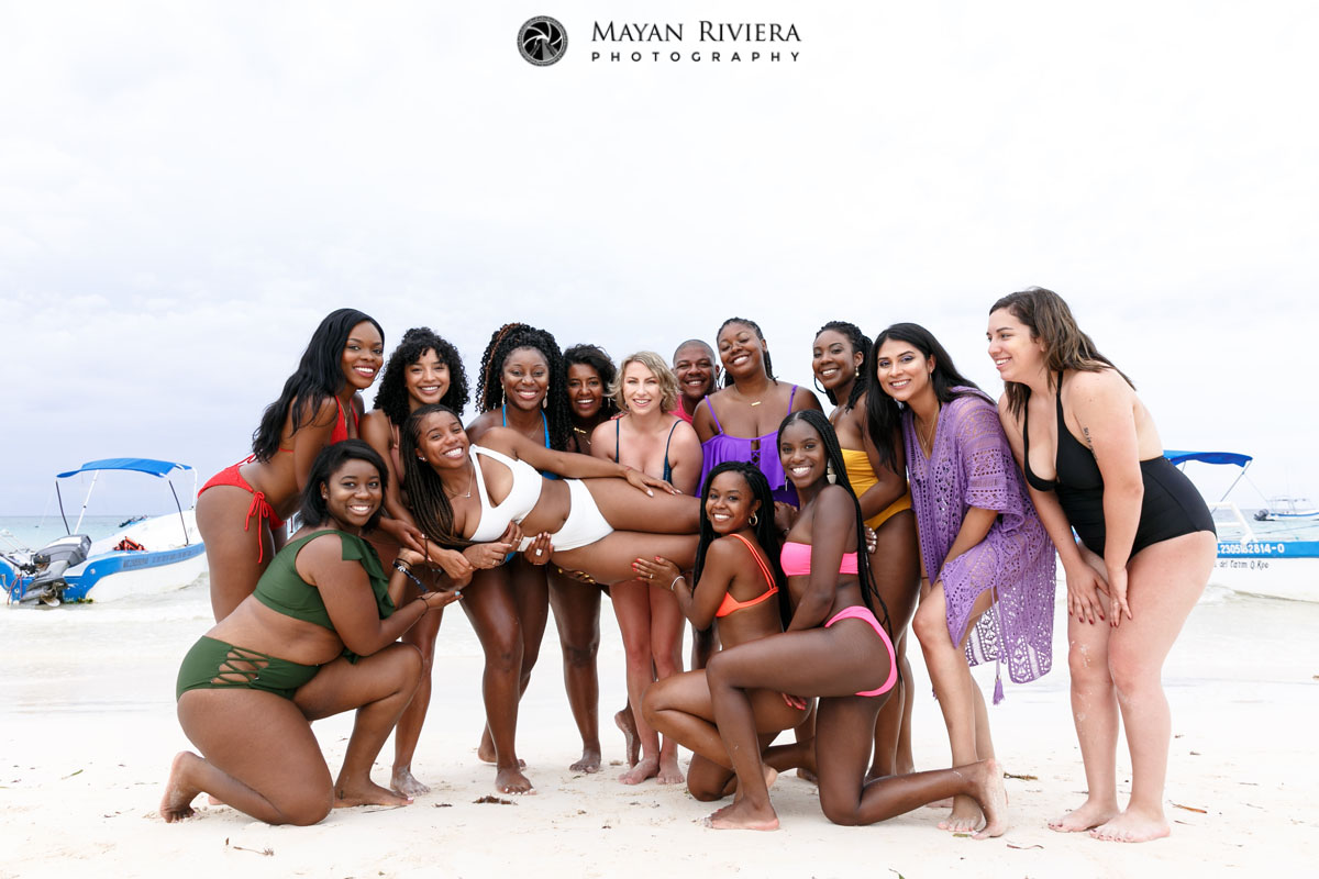 BestiesHoldRecliningBrideInArmsOnBeach