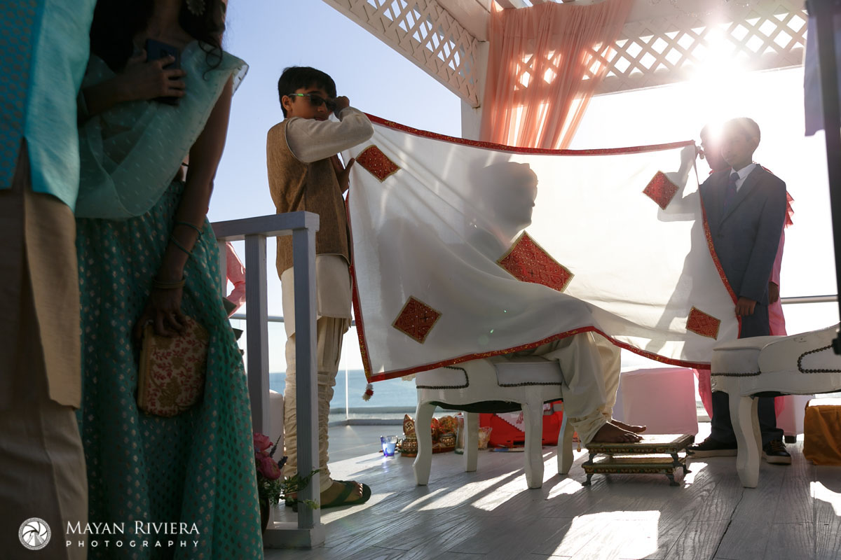 HinduAttendantsShieldGroomWithCurtain