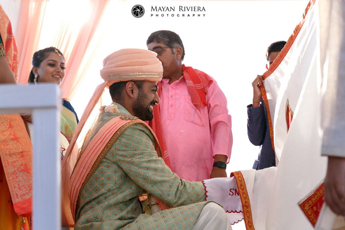 HinduGroomSitsBehindCurtainShield