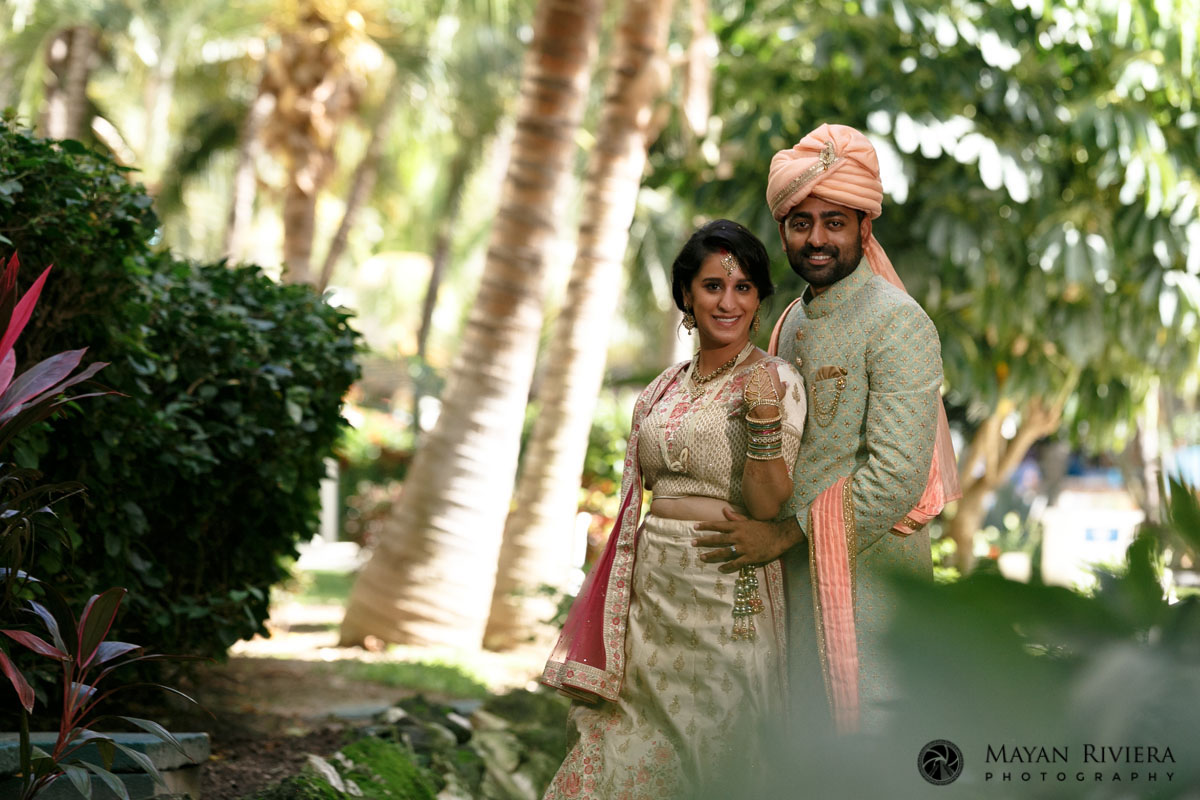 Hindu newlyweds pose in resort garden