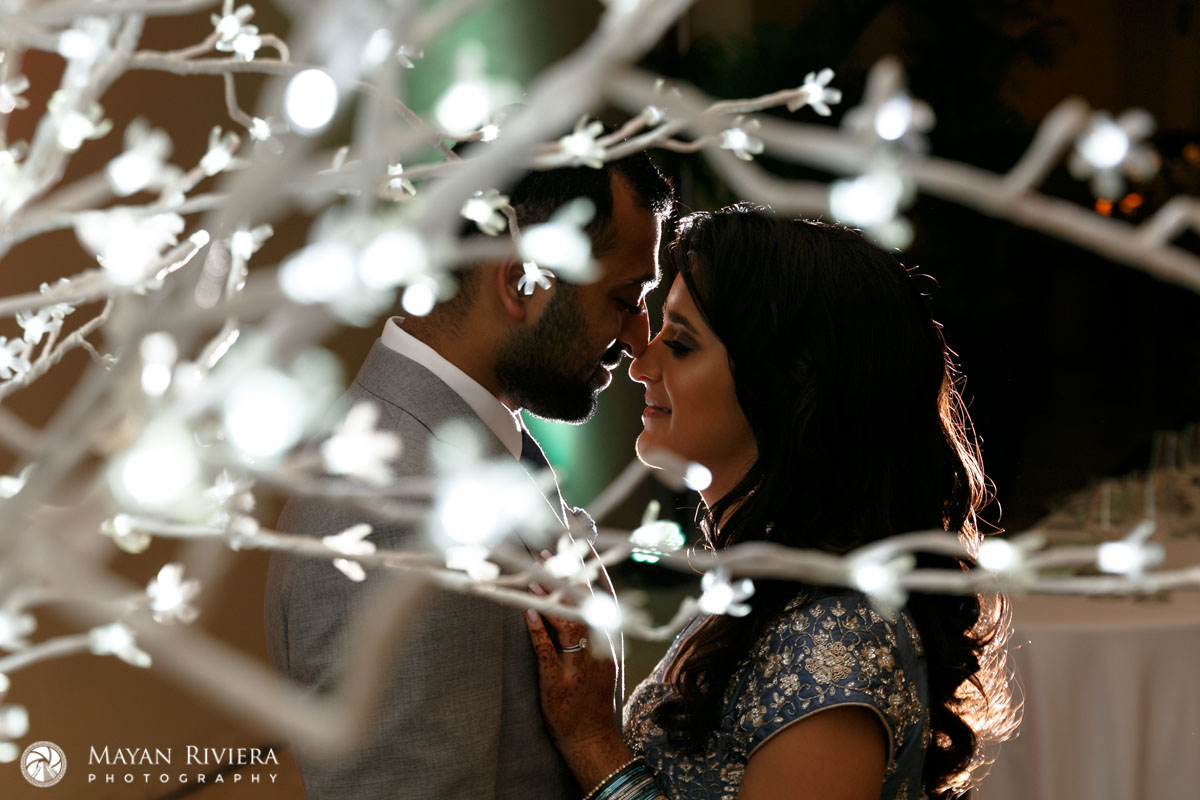 HinduNewlywedsFaceEachOtherByTreeLights