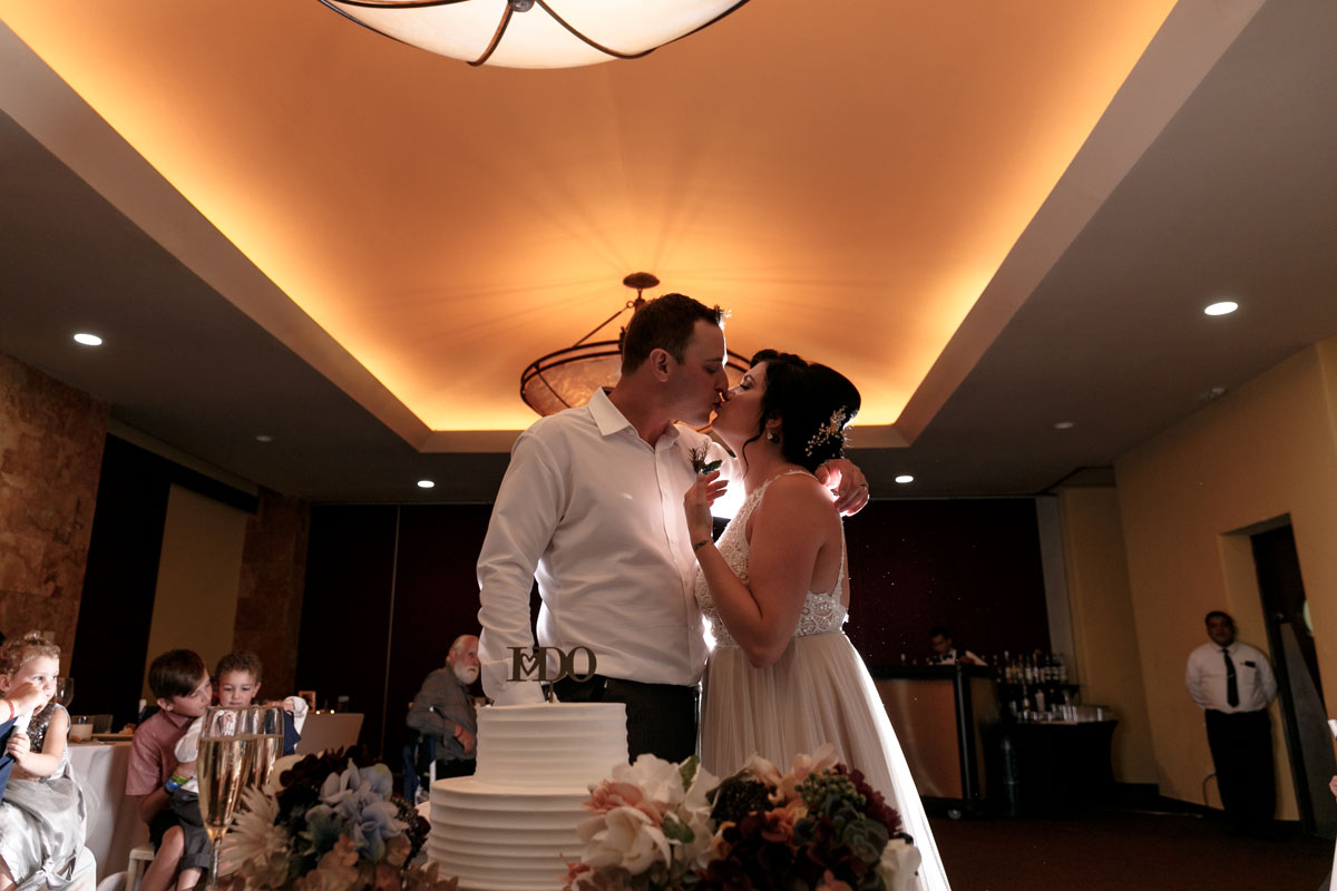 NewlywedsKissAfterSharingCake