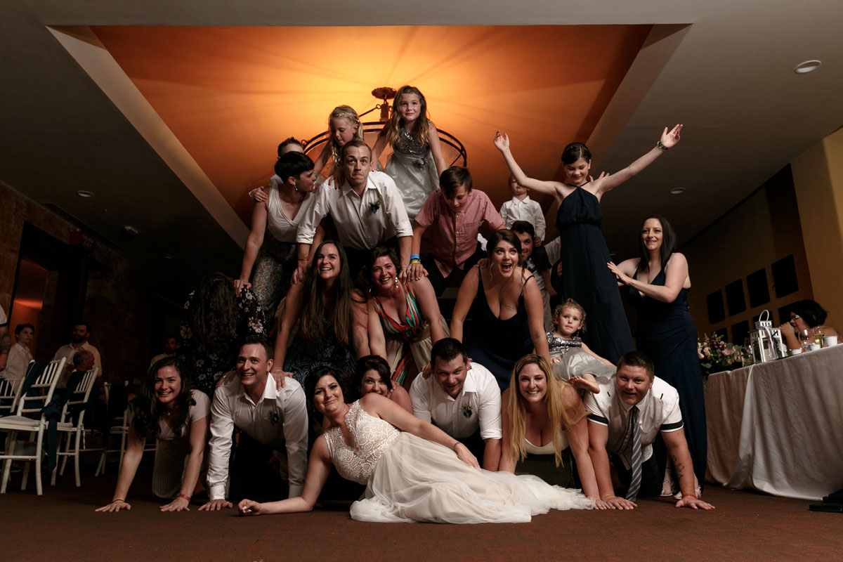 KidPyramidBehindNewlywedsRecliningOnFloor