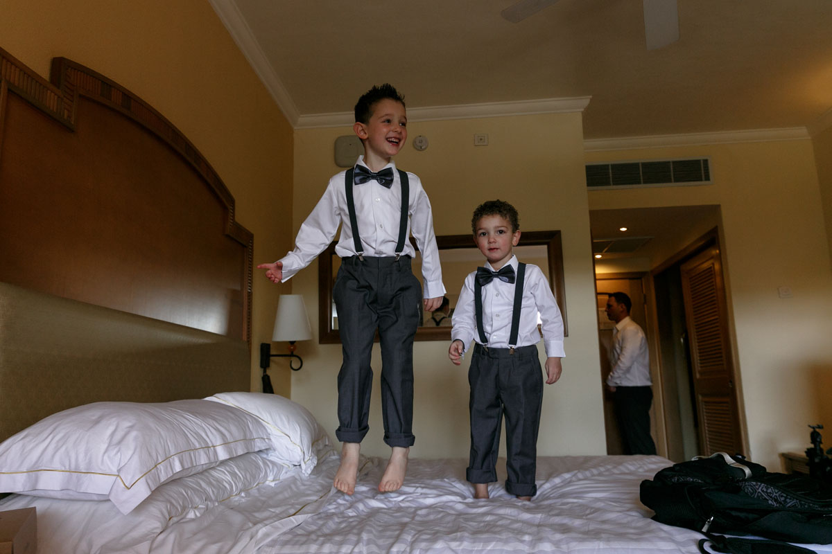 SmilingBarceloRingBearersJumpOnBed